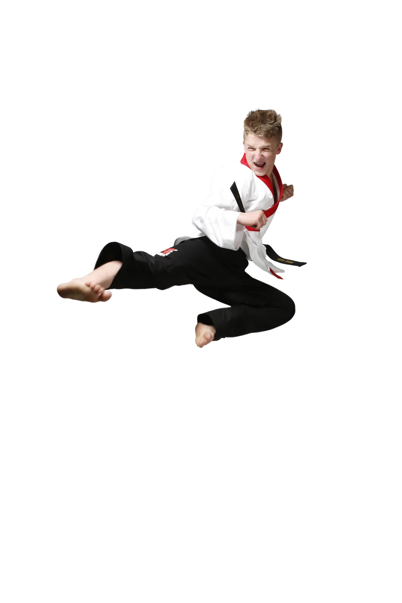 A teenage black belt in a red-collared uniform performing a flying side kick.